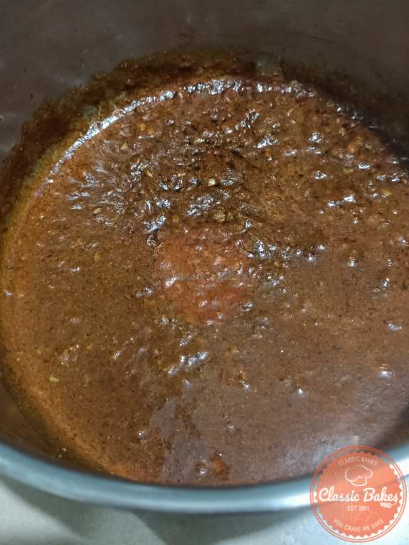 Onion pate added to spice mixture in a pot