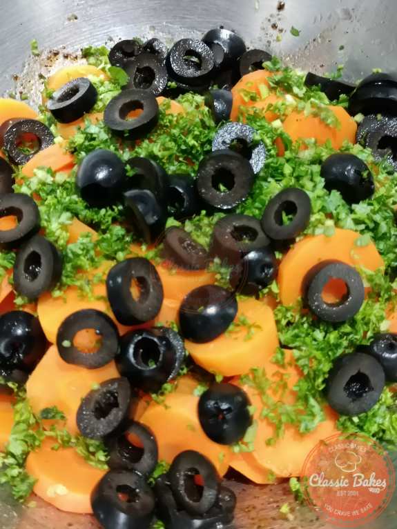 Mixing in the steamed carrots, parley and olives