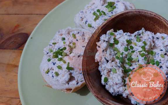 Put the everything bagel dip into a serving bowl and top with scallions and the leftover everything bagel seasoning.