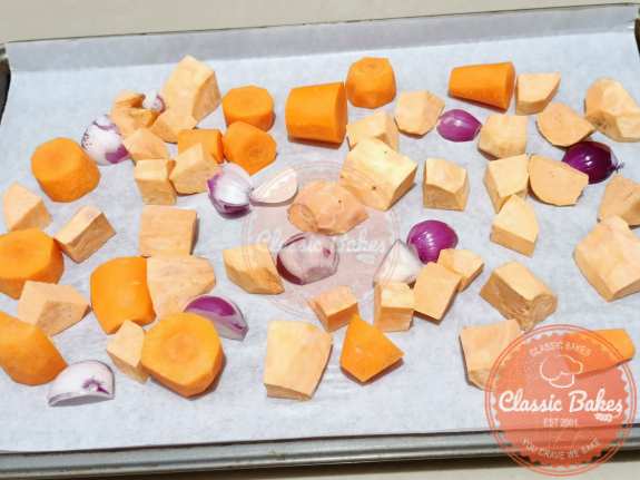 Prepare sweet potatoes, shallots and carrots for baking