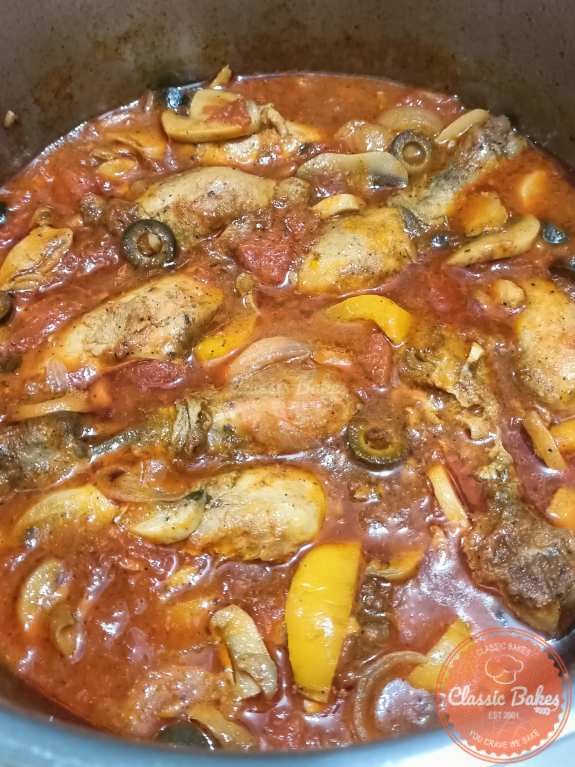 Adding chicken and olives