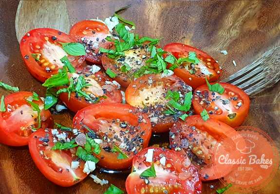 In a bowl, mix the Roma tomatoes with olive oil, balsamic vinegar, sea salt, pepper, and basil.