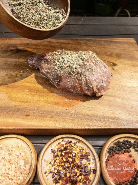Coat the entire sirloin tip roast with olive oil, and then evenly apply the spice rub all over the roast, pressing it in to make sure the seasoning adheres to the meat.