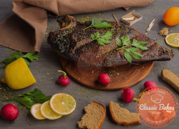 Fish on a cutting board with garnish