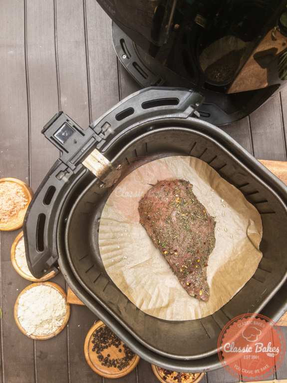Put the sirloin tip roast into the air fryer and cook it for 15 minutes, or until it achieves a golden brown color.
