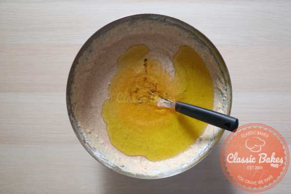 Adding olive oil to the mixture in a bowl