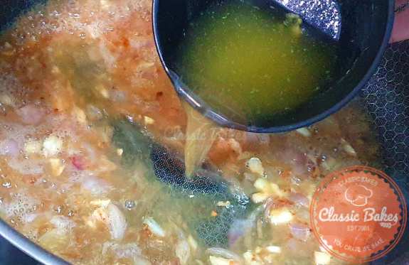 Afterward, incorporate the chicken broth, stirring to combine. Reduce the heat to low and let it simmer for 4–5 minutes or until it reduces by half.