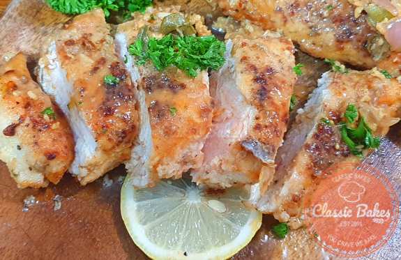 Pour the sauce over the chicken breasts and garnish with fresh parsley.
