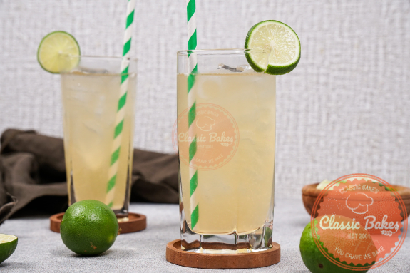 2 highball glasses of fresh lime juice with green straws