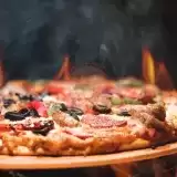 Front shot of Homemade Pizza with fire background