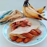 Closed up Fried Plantain and Roti on a plate with banana on side