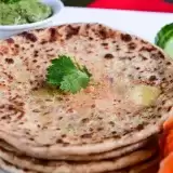 Aloo Puri with carrots and cucumber on the side