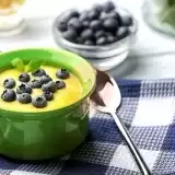 Cornmeal Porridge in a bowl topped with blueberries