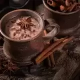 Front shot of Chocolate Tea in a ceramic cup with cinnamon on the side