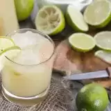 Fresh Lime Juice with knife and cutting board on side