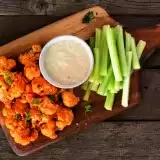 Aerial shot of Cauliflower Bites with a dip and celery on the side