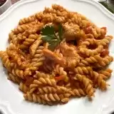 Front shot of Fusilli Pasta with Chicken in a plate with garnish