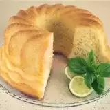 Font shot of sliced Jamaican Rum Cake with lime and basil on the side