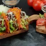 Keto Taco with beef and crunchy cheese shells on top of wooden board