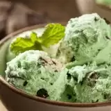 Front shot of Mint Chocolate Chip Ice Cream in a bowl with mint leaves