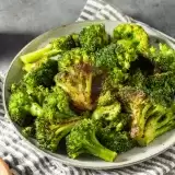Roasted Broccoli with Parmesan in a bowl on top of a cloth