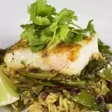 Front shot of Grilled Cod with Wild rice and Sugar Snap Peas with parsley on top