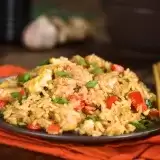 Front shot of Guyanese Style Fried Rice in a plate with chopsticks on the side