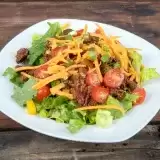 Front shot of Keto Taco Salad in a plate on wooden background
