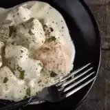 Aerial shot of Low Carb Chicken Alfredo in a plate with a fork on the side