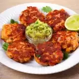 Front shot of Keto Salmon Cakes in a plate with lime on the side