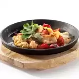 Front shot Keto Low Carb Chicken Stir Fry in a ceramic pan on top of wooden board