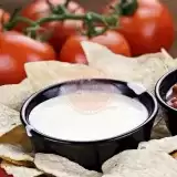 Front shot of Keto Queso Dip in a bowl with chips 