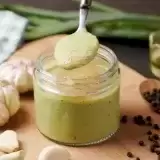 Trinidad Garlic Sauce being scooped by a small spoon