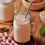 Trinidad Peanut Punch in a glass jar with a straw.