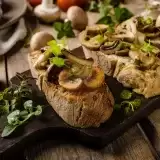 Front shot of Vegan Mushroom Bruschetta in a wooden board