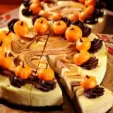 Whole Pumpkin Swirl Cheesecake on top of wooden board