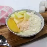 Coconut Pudding in a bowl with a mango slices on top