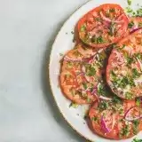 Overview of a platter of heirloom tomato salad on a countertop 