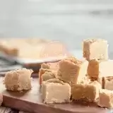 Sideview of peanut butter fudge cut up on a plate 