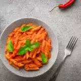 Overview of a bowl of Pasta Arrabiata on a countertop 