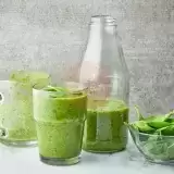 Sideview of two glasses and a jug of Spinach Smoothie 