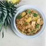 Overview of a bowl of pineapple fried rice on a table top 