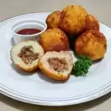 Front view of Stuffed Potato Balls on a plate