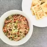 Overview of a bowl of choka salad next to a plate of crackers