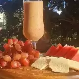 Grape Smoothie with fruits and crackers.