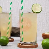 2 highball glasses of fresh lime juice with green straws