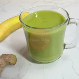 Ginger Smoothie in a cup next to a banana